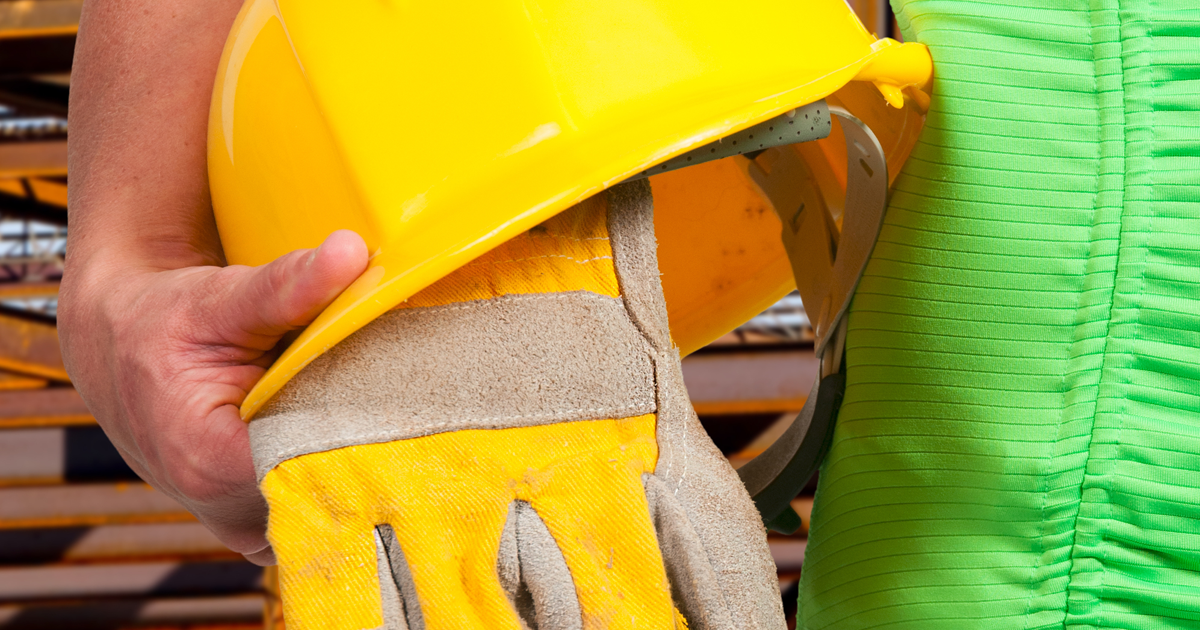 woman holding construction hard hat