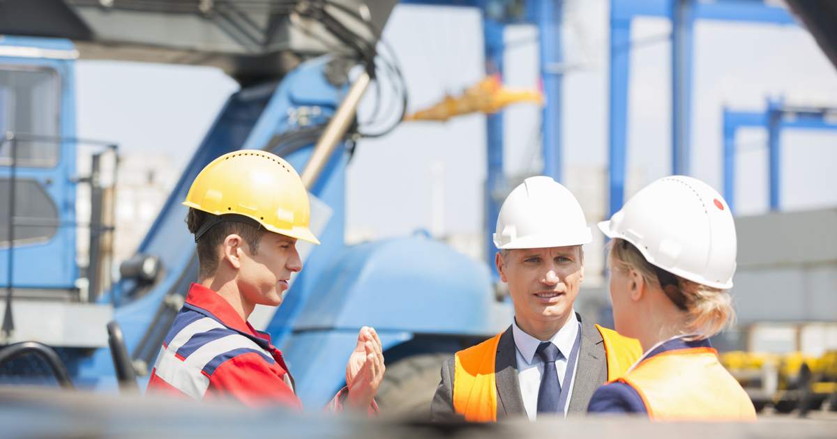 three workers on a construction site