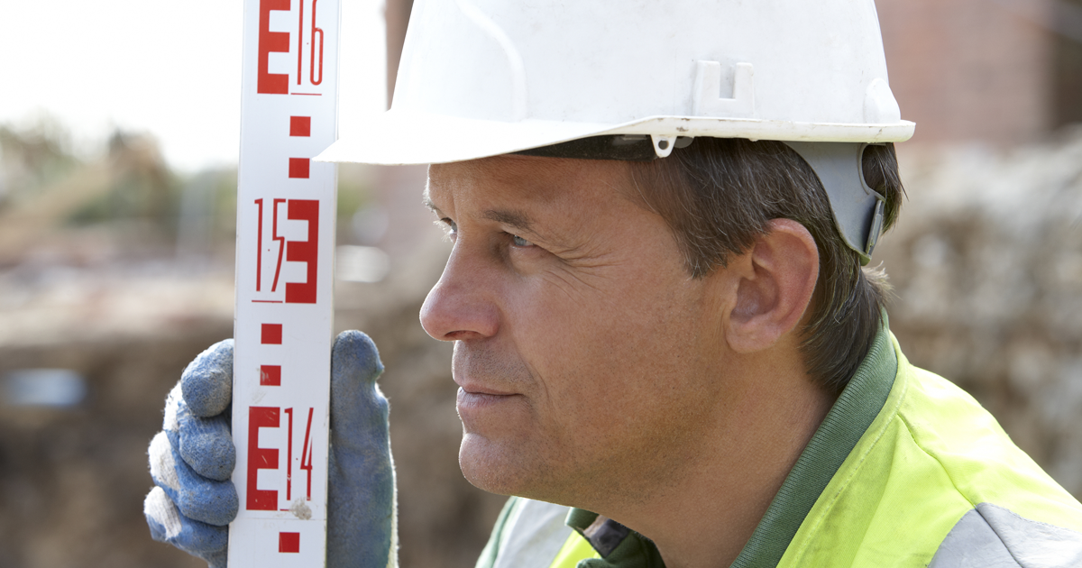 construction worker measuring