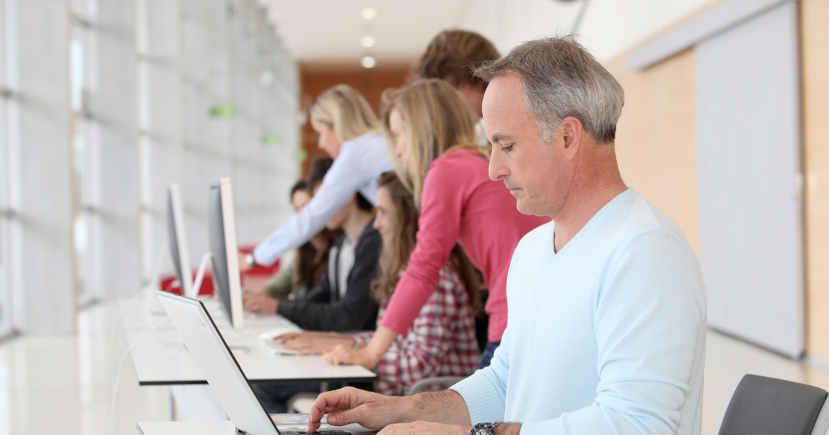 man sitting at table doing work