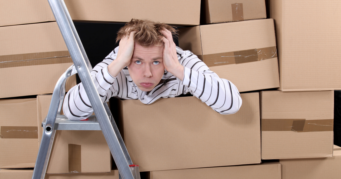 stressed package handler surrounded by boxes