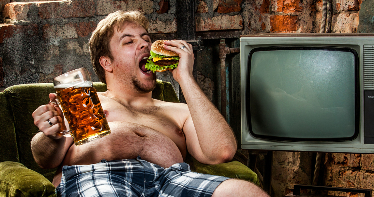 fat man eating a burger in a chair