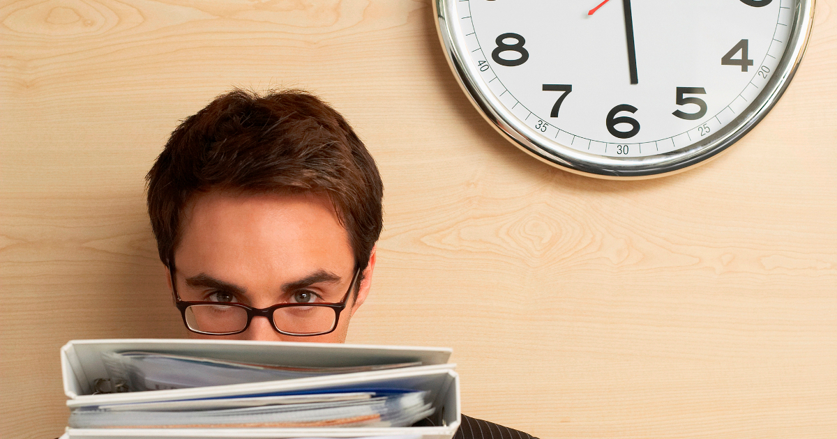 man with binders working late