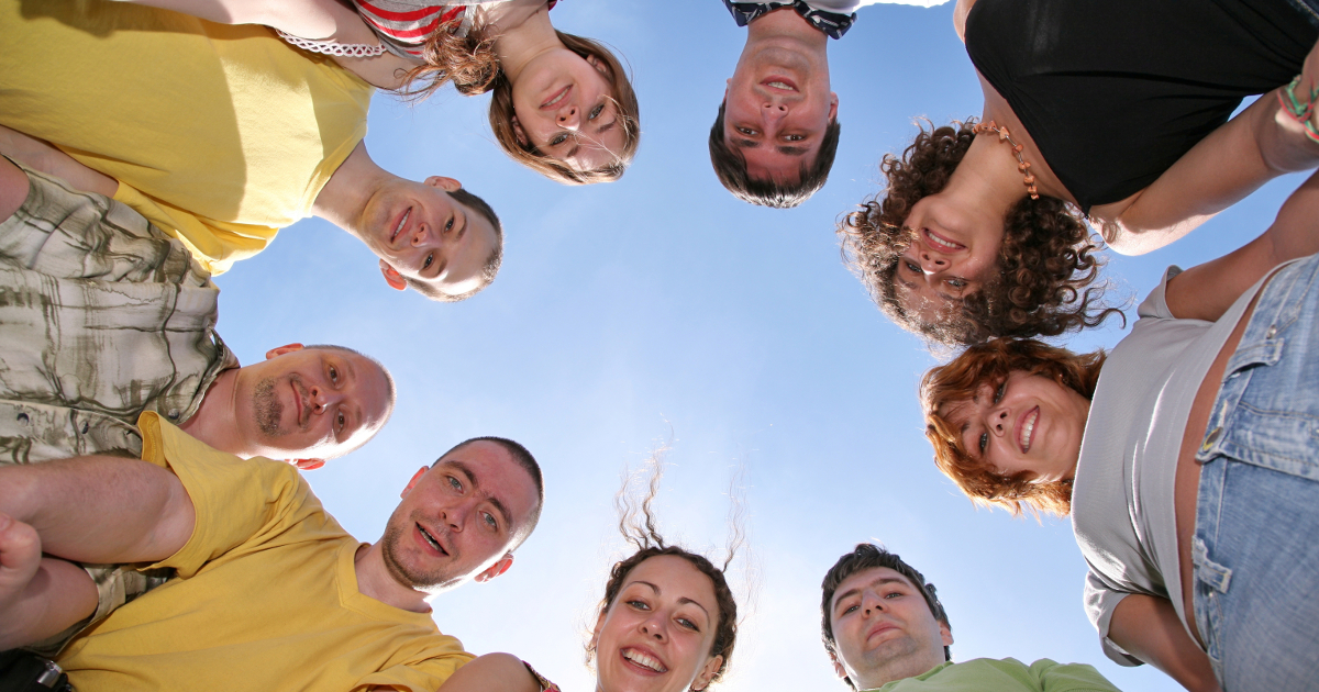 group of people looking down at camera