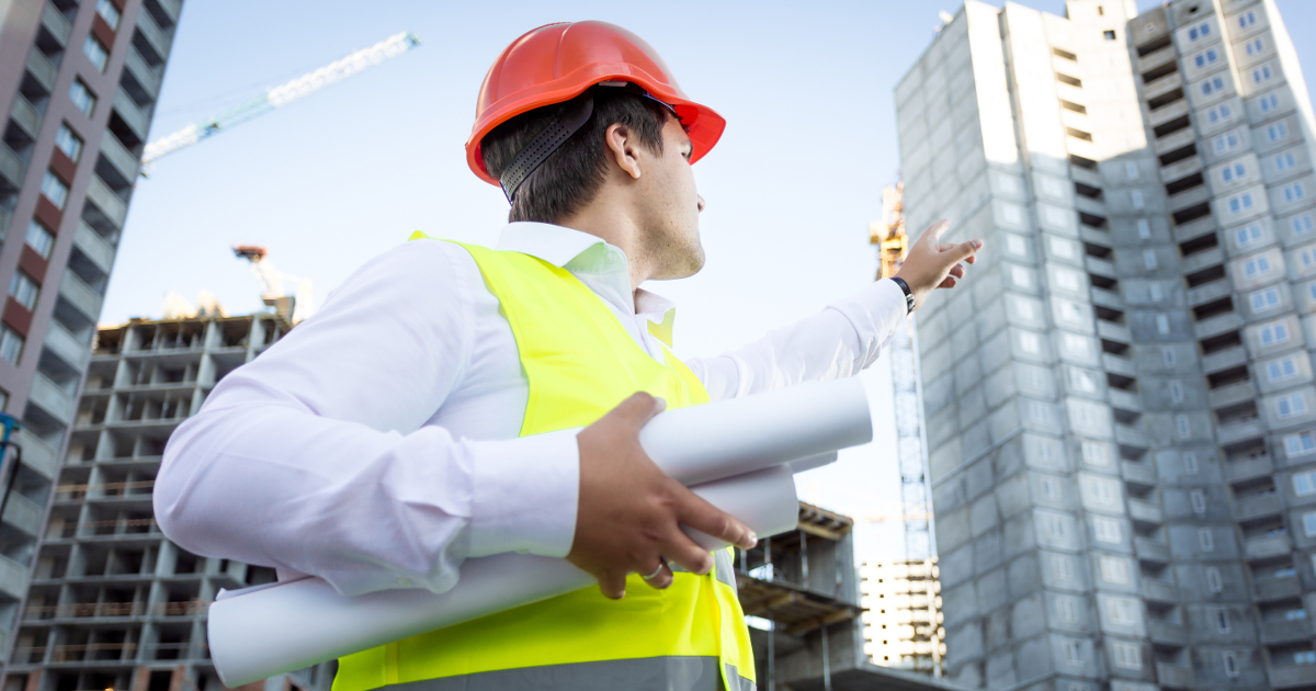 safety leader pointing at building