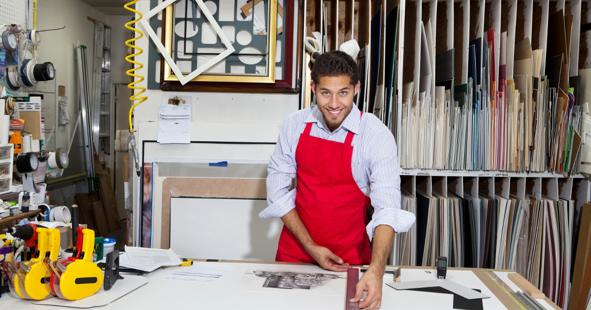 portrait of a happy skilled worker measuring with meter stick