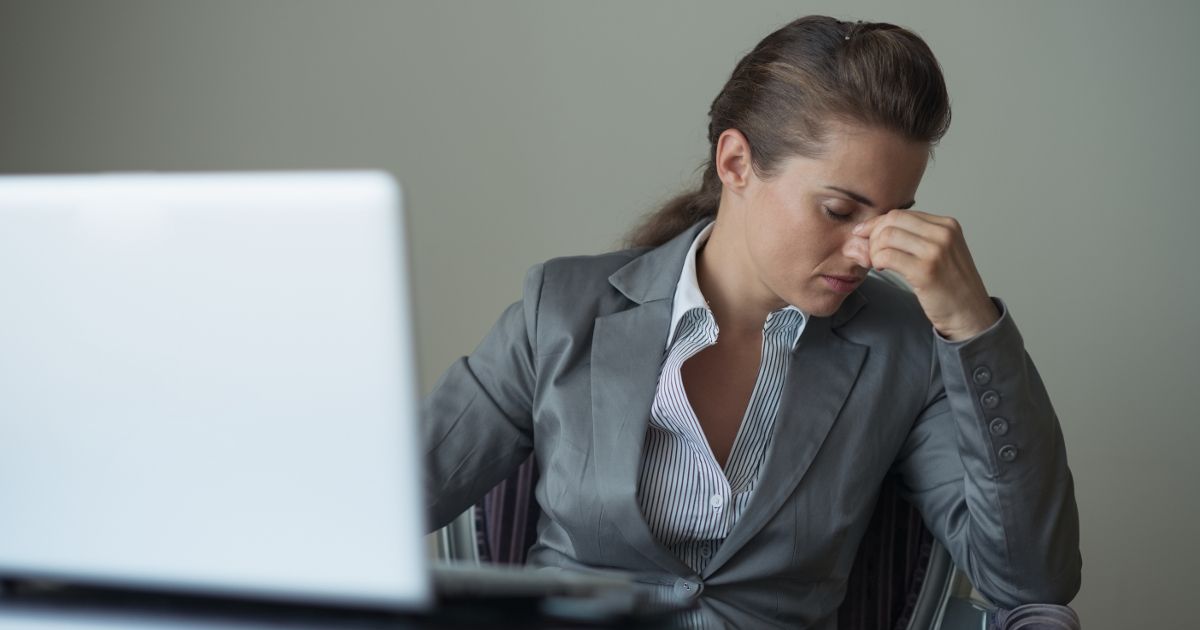 depressed business woman sitting at desk