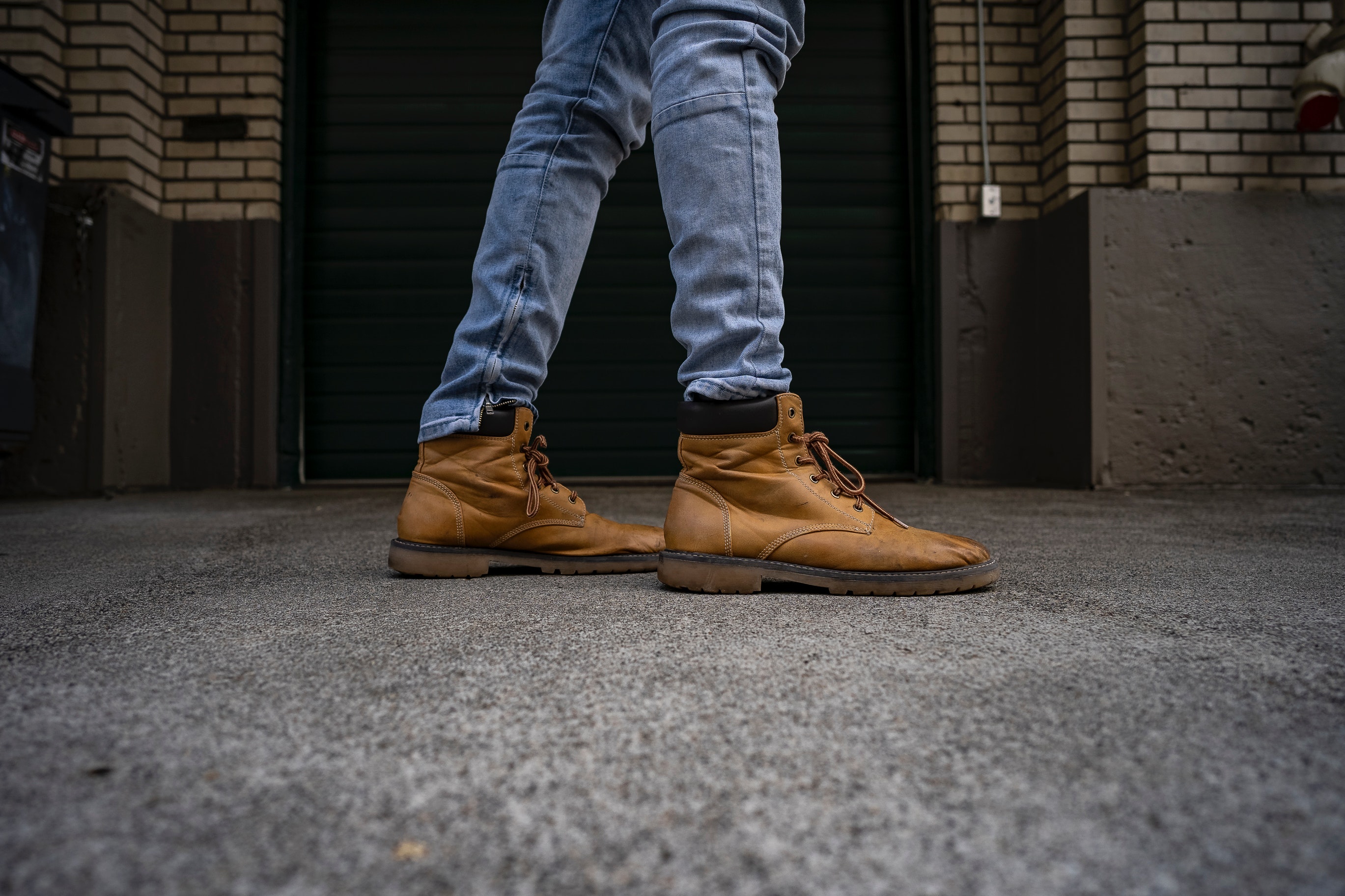 legs in boots and blue jeans